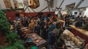 A photo of a crowd of people inside a market.